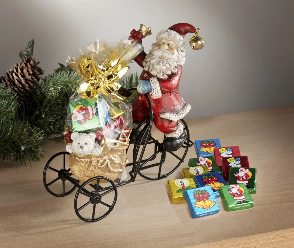 Weihnachtsmann auf Metalldreirad mit Teelichthalter